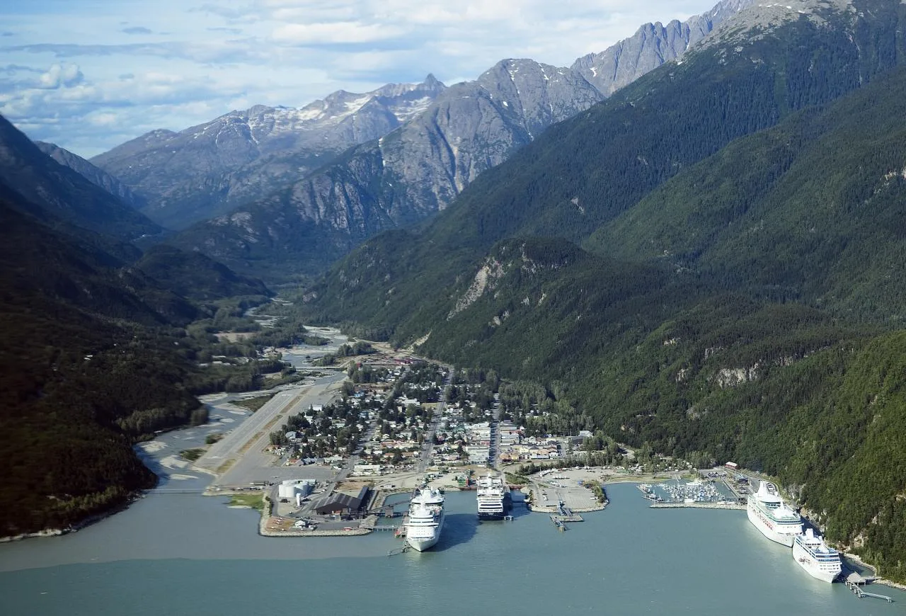 Aerial view of compact Skagway between the inlet, river, and steep mountain valley